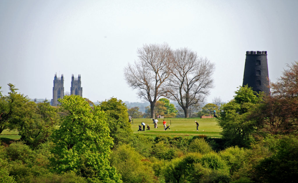 Players teeing off at the Par 3 6th at Beverley & East Riding Golf Club, against the backdrop of Beverley Minster
