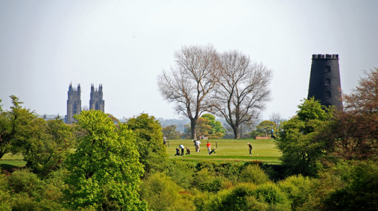 Players teeing off at the Par 3 6th at Beverley & East Riding Golf Club, against the backdrop of Beverley Minster