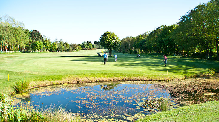 A view of the Par 4 5th green at Hornsea Golf Club, which is well-guarded by a pond on the right hand side