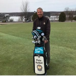 A photo of Pete Kelbel standing behind his Callaway Golf Bag