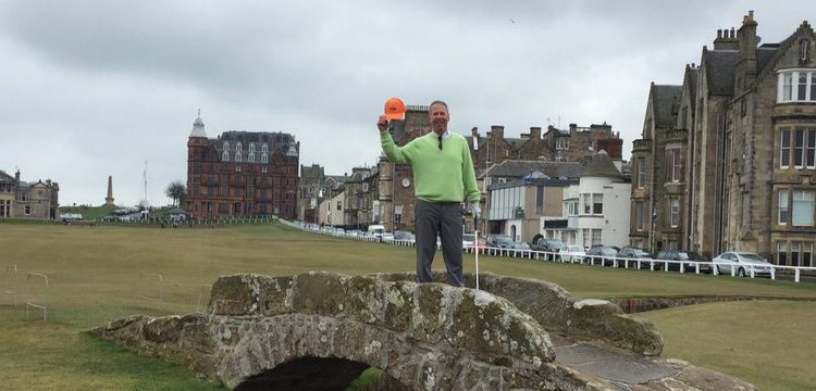 A photo of Pete Kelbel standing on the Swilken Bridge on the 18th Hole at the Old Course, St AndrewsA photo of Pete Kelbel standing on the Swiken Bridge, Old Course, St Andrews