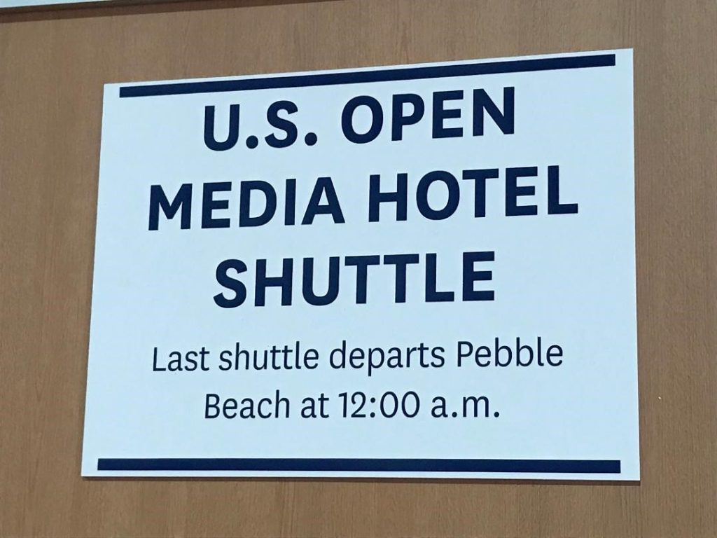 A photo of the sign displaying information for the US Open Media Hotel Shuttle