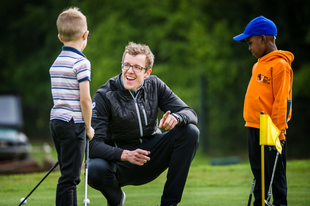 A photo of Thomas Devine engaging with Junior Golfers on the FUEL Junior Golf Programme at Oulton Hall