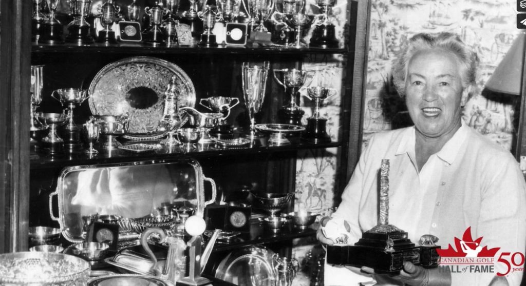 Photograph of Ada Mackenzie next to her Trophy Cabinet, by kind permission of Golf Canada