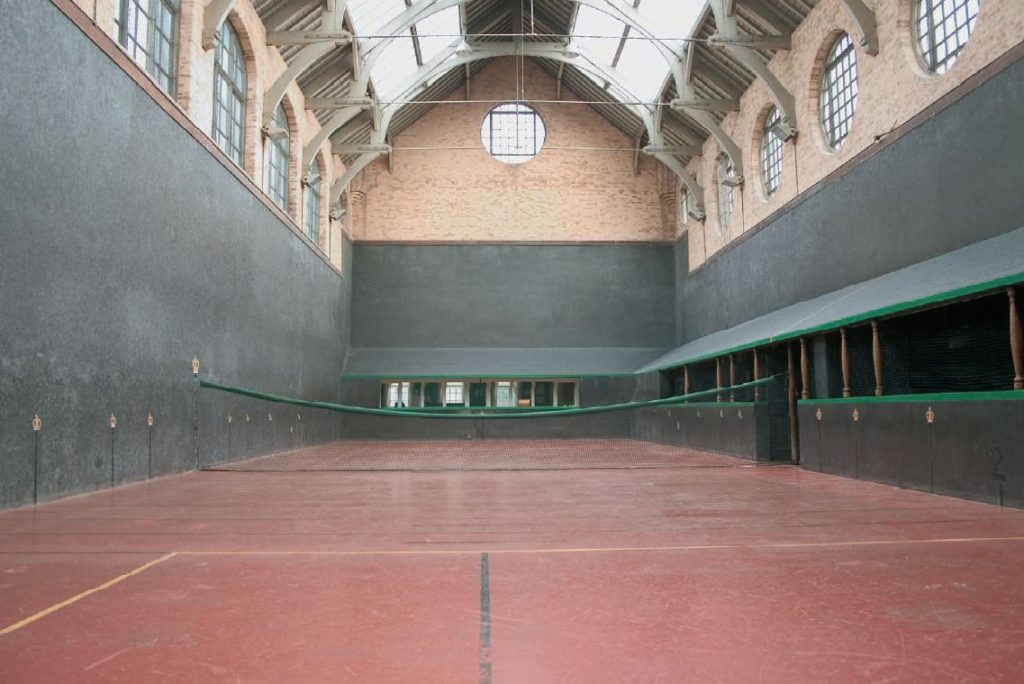 From 2005...a view of a Real Tennis Court at Jesmond Dene Real Tennis Club, Newcastle Upon Tyne, England (photograph attributed to Horacio Gomes, CC BY-SA 3.0 , via Wikimedia Commons)