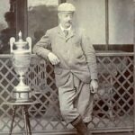 A photograph of Freddie Tait standing with the Amateur Championship Trophy