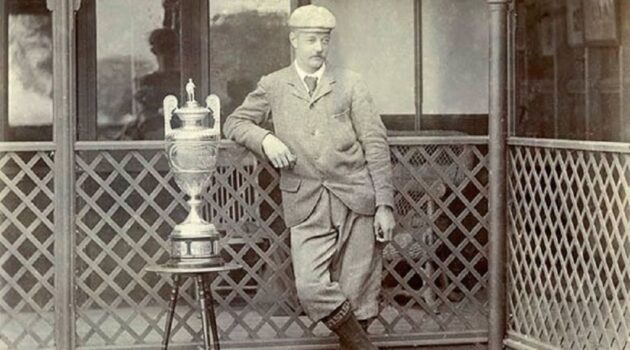 A photograph of Freddie Tait standing with the Amateur Championship Trophy