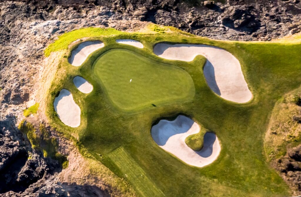 Aerial view of the iconic par 3 7th green at Pebble Beach Golf Links