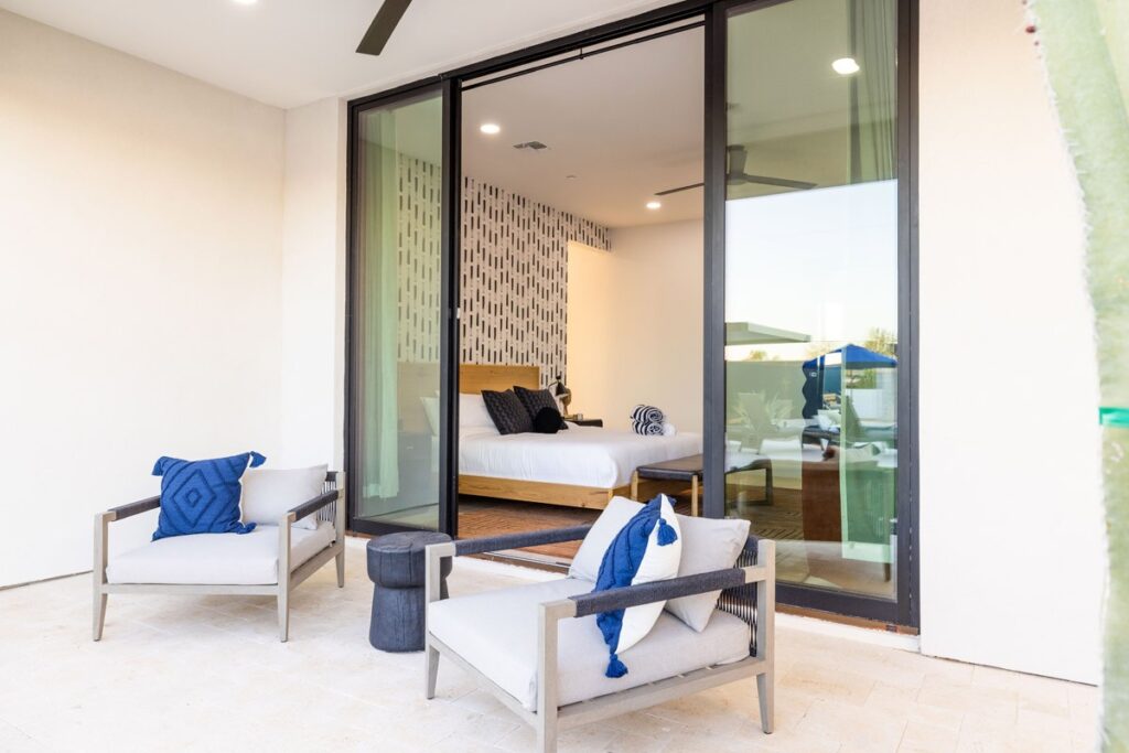 Photograph of bedroom and outside seating area at golf hotel accommodation ... by kind permission of HÓZHÓ Estate on Thunderbird